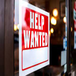 help wanted sign hanging in window